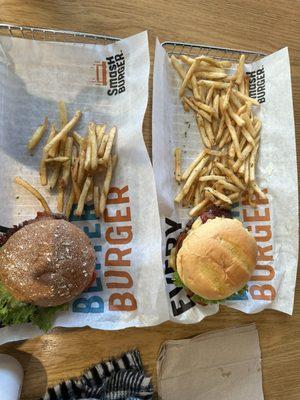 on the left is the AVOCADO BACON CLUB BURGER and the right is the DOUBLE BACON SMASH BURGER with a LARGE SMASHFRIES