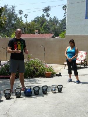 Teaching a beginner kettlebell swing class for the Miracle Fitness girls