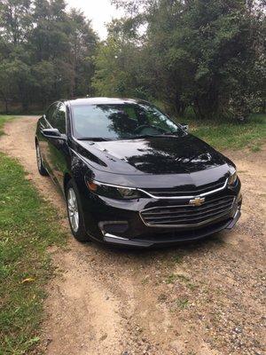 2016 Chevy Malibu 1LT   27 mpg city / 37 mpg highway Black on Black with metal fleck.