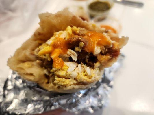 Breakfast burritos are fresh, hot, and flavorful. Good size too. One of my favorite menu items. Shown here with delicious orange hot sauce.