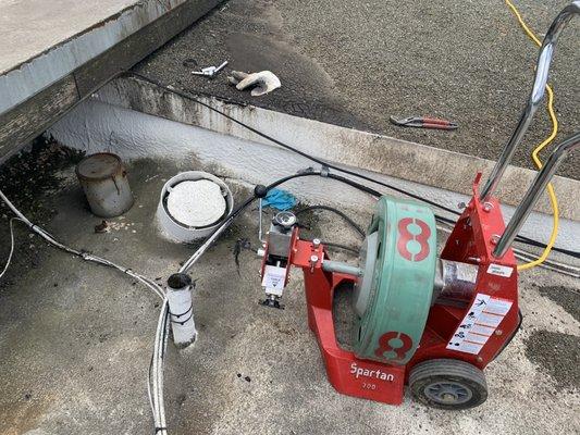 Running sewer machine from rooftop of Crockett fire department building