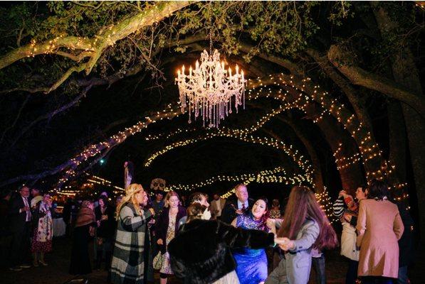 Guests dancing under the trees in the oak forest at Oak Hollow Farm.