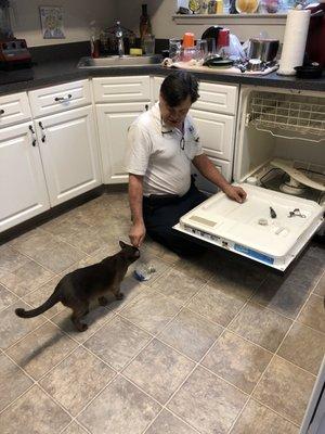 Mike repairing the draining issue with our dishwasher.  Our cat supervised. Mike got a two paws  up!