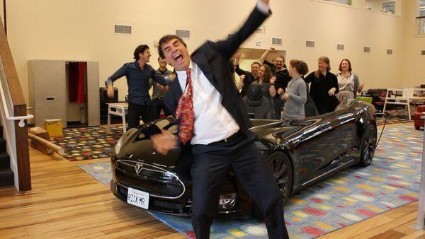 Tim Draper in front of the "Deskla," the reception desk created out of a Tesla