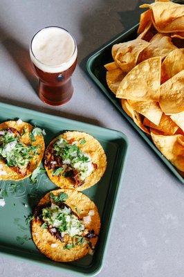 Chips and salsa are always free. (shown: vegan maitake mushroom tacos, house-made corn chips)