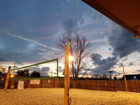 Sand volleyball and sandbag toss game and music