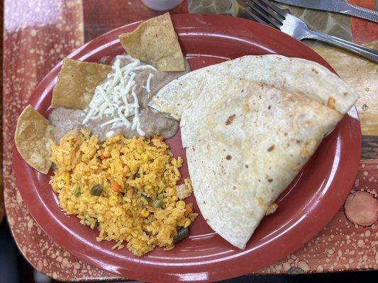 Chicken and cheese quesadilla with a side of rice and beans