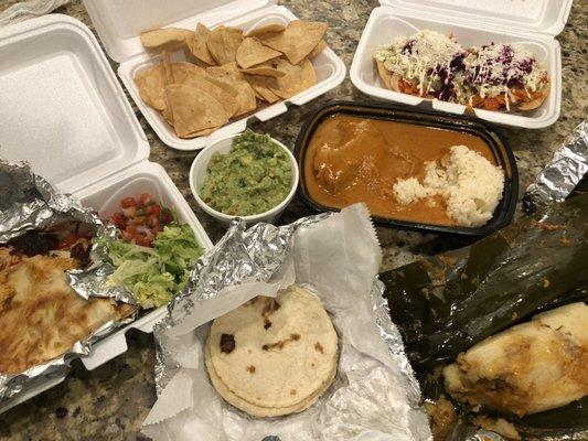 Chicken quesadillas, chips and guacamole, pepian (chicken stew), chicken tamales, and enchiladas in the back.