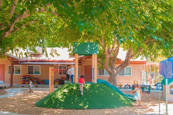 A variety of age-appropriate playground equipment allows children to practice and improve gross motor skills.