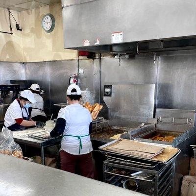 Aunties making fresh fried doughnut sticks.