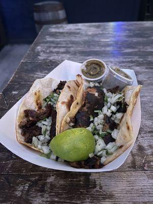 Smoked Brisket en Mole Tamarindo Taco and lamb barbocoa taco