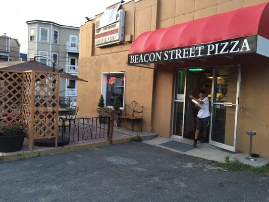 Outside, entrance and outdoor seating area.