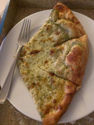 One slice short of a half of a LoCoco's large pesto pizza.