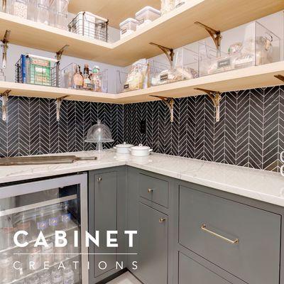 The marble chevron backsplash ties in the iron ore (sherwin williams) color on the cabinetry.