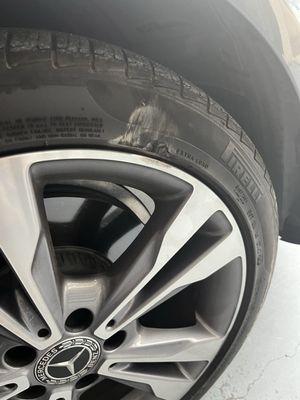 Tire scuff, wheel damage, and chunk of tire loss