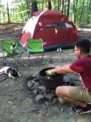 Cooking corn in the fire pit while the girls look on