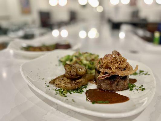 Marinated Sirloin served with Brussels sprouts Hash, Roasted Fingerlings topped with fried onion straws and VG Steak Sauce