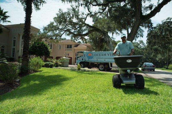 Our pest control manager applying granular fertilizer.