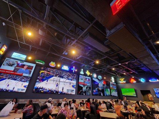 The Tvs to watch the game and the dining area.