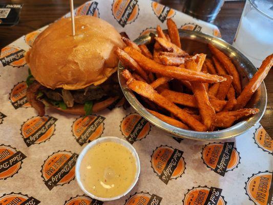 Bistro burger with Angus beef, bacon, gouda cheese, onions, avocado crema and sweet potato fries