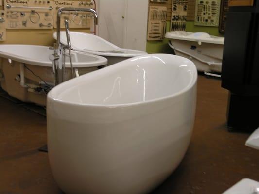 Over a dozen tubs on display, freestanding in both modern & traditional styles, standard baths and larger tubs with jets or air