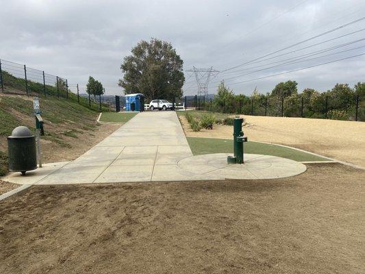 Water area, plenty of trash cans , large fine gravel area