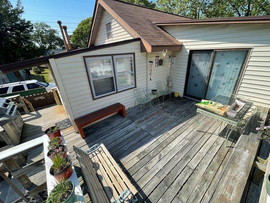 A before picture of a deck/siding/ and screen door we have posted