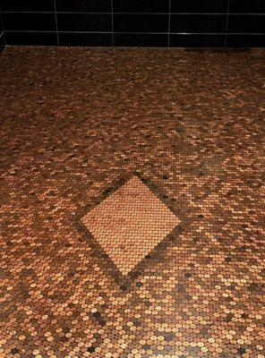 Bathroom floor made of pennies