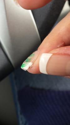 She filed off part of the french tip! And it has excessive glue!