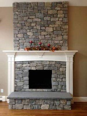 Liberty Hill Ashlar thin veneer stone fireplace with a Smokey Mountain Granite hearth.