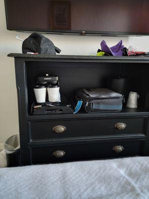 The coffee maker has to be moved to use it to the only place in the room with sockets, one of the bedside tables.