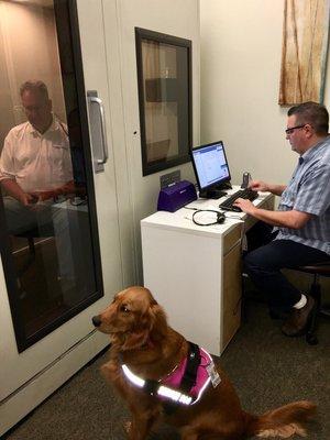 Dad getting his hearing tested, he just adores their dog. I bet he'd take her home if given the chance.