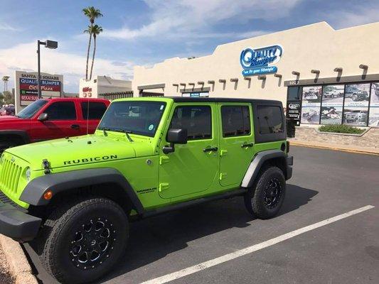 Jeep Wrangler with Amp PowerStep Running Boards installed at our Mesa Store