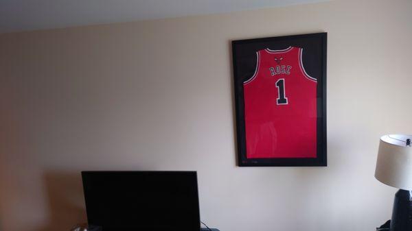 Hung a framed autographed Derrick Rose Jersey