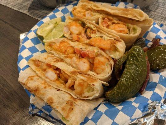 Shrimp quesadilla with grilled jalapeños and limes