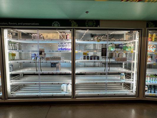 Empty dairy case at Whole Foods.