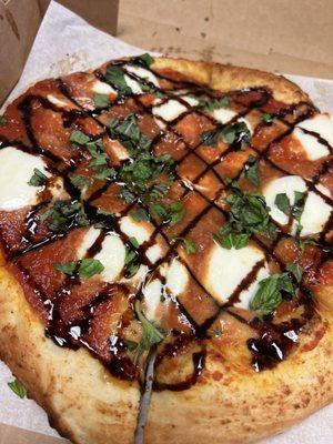 The most delicious Margherita Pizza! Topped with Marinara sauce, fresh mozzarella, basil & house made balsamic drizzle