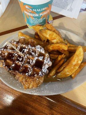 Chicken and waffles sandwich with potato wedges