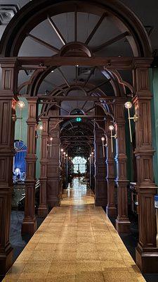 Love this hallway with the teak corridor and scones that is reminiscent of markets with a sand floor