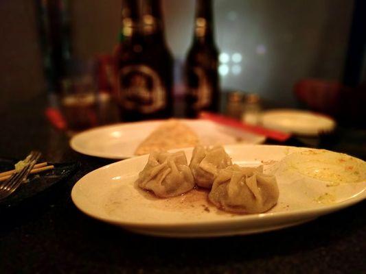 Buuz in foreground and one khuushuur in the background. Both are good.