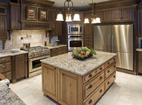 Over-sized kitchen island by Madison Oak Cobblestone combines ample serving or preparation space with storage.