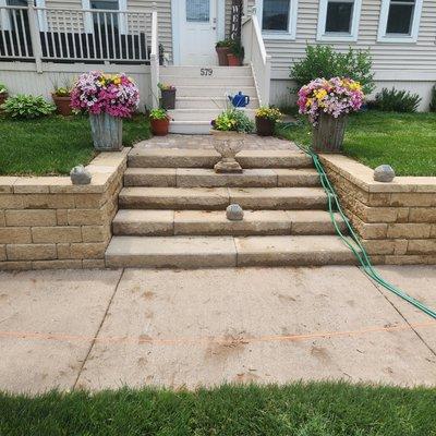 Retaining wall with a short paver sidewalk and brand new grass