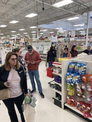 Long ridiculous lines of customers awaiting to checkout items.