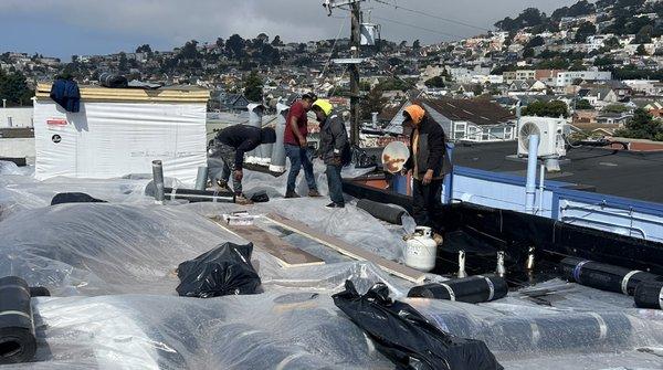 Their crew was on my roof when the dripping began. The plastic wasn't attached. Note the uncovered insulation that also got soaked.