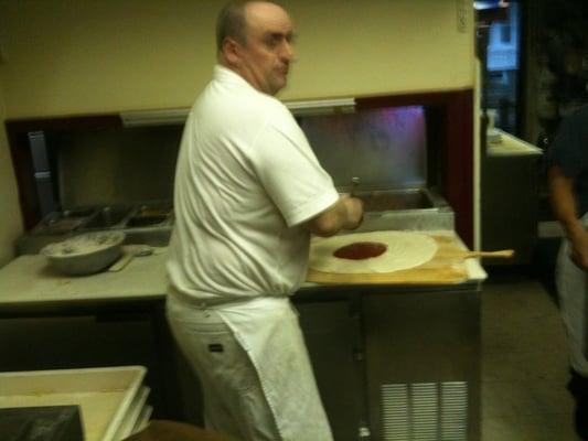 John making pizza.