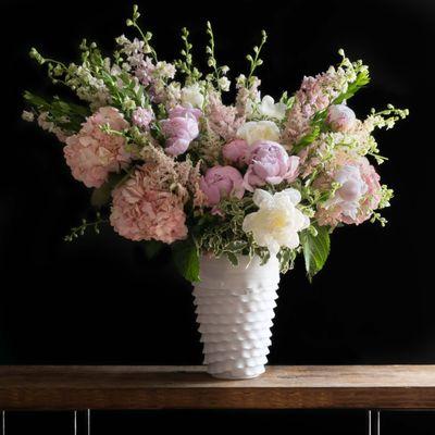 Beautiful tall floral arrangement with soft pink peonies, roses, and hydrangeas.