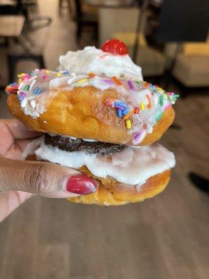 I think they called it the Izzy Piggy: 2 vegan donuts, chocolate icing in the middle, topped with whipped cream and a cherry. All vegan.