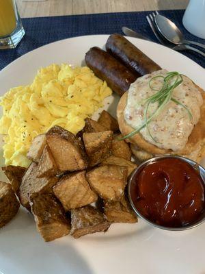 The Eye Opener - Two Eggs any style, Breakfast Potatoes or Grits, Applewood Bacon or Sausage and a Biscuit topped with Sausage Gravy.