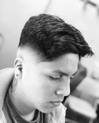 Mid skin fade with scissors on top