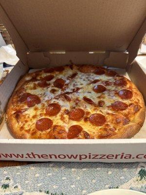 A fresh pepperoni pizza in the box.